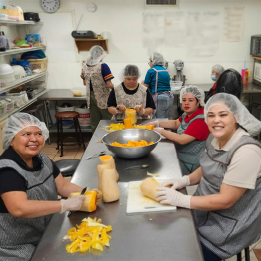 Baker apprentices peeling and chopping squash for pumpkin empanadas