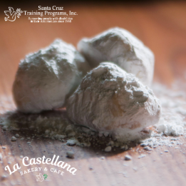 Butter and pecan cookie balls rolled in powdered sugar.