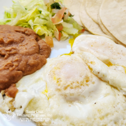 Two eggs with beans and tortillas