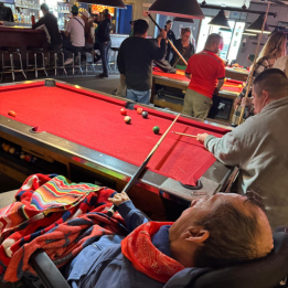 Members playing pool at the local bar in Nogales.